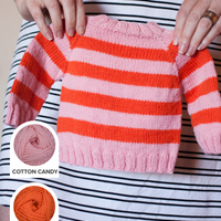 A striped, top-down seamless baby sweater in pink and orange Ewe So Sporty merino wool.